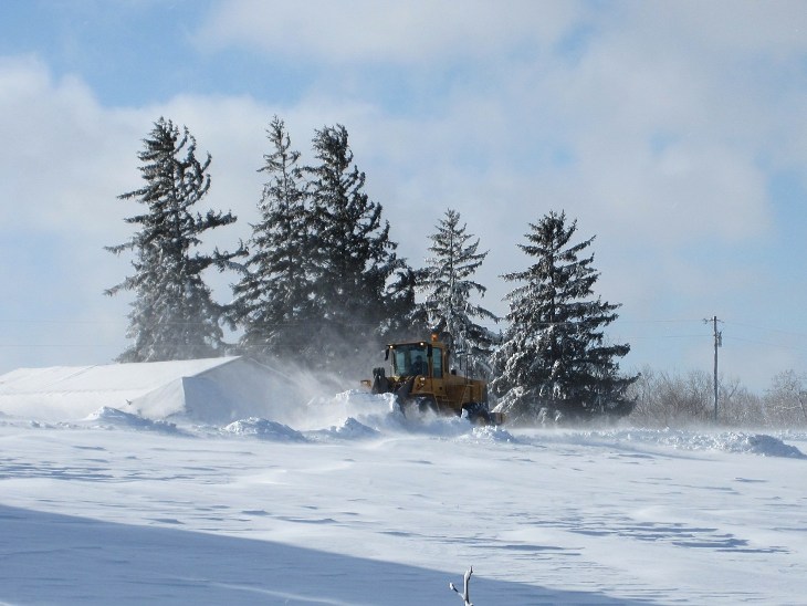 End loader digs out the road after big snowstorm